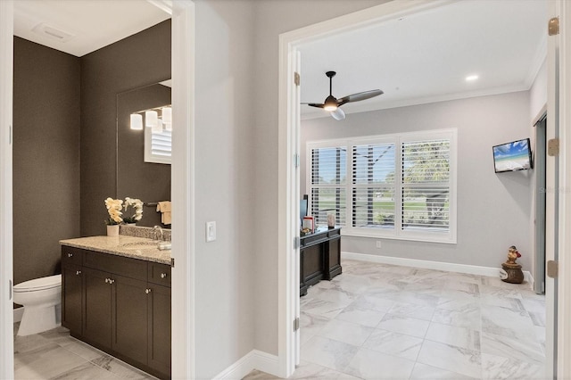 bathroom featuring ceiling fan, toilet, crown molding, and vanity