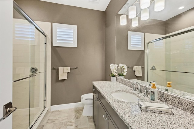 bathroom featuring toilet, an enclosed shower, and vanity