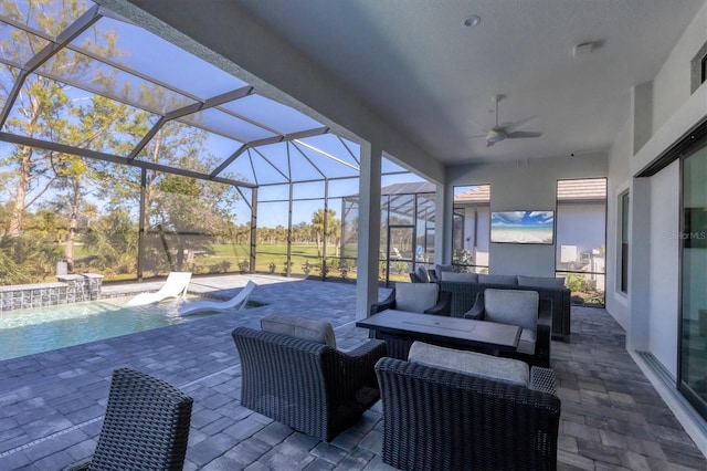 view of patio with glass enclosure, ceiling fan, and an outdoor living space