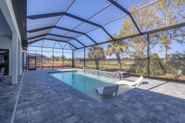 view of swimming pool featuring pool water feature, a patio area, and a lanai