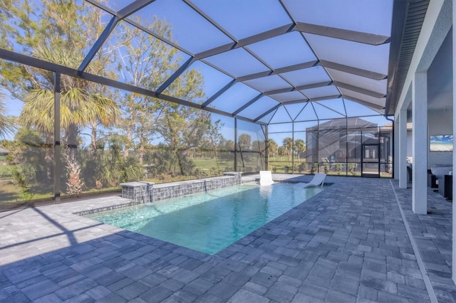 view of swimming pool featuring pool water feature, a lanai, and a patio