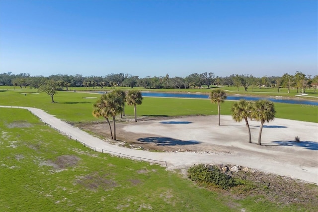 view of home's community with a yard and a water view