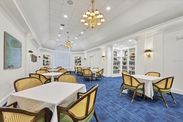 dining space with dark colored carpet, an inviting chandelier, built in features, and ornamental molding