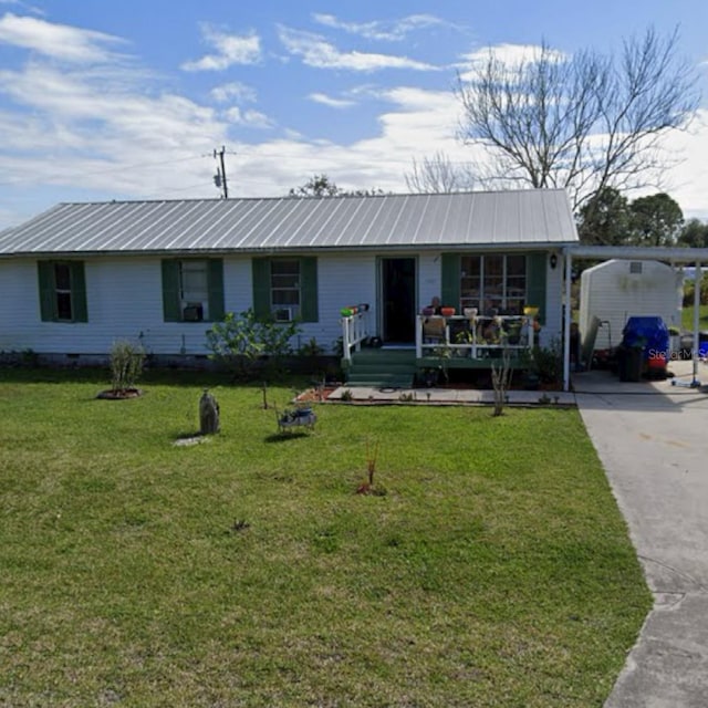 single story home with a front yard and a carport