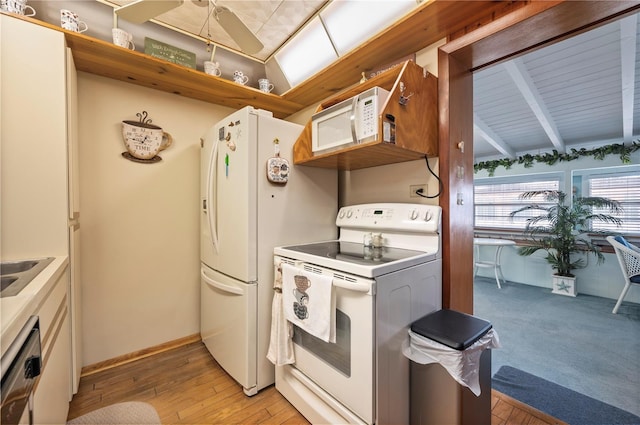 kitchen featuring white appliances, white cabinets, light hardwood / wood-style flooring, and vaulted ceiling