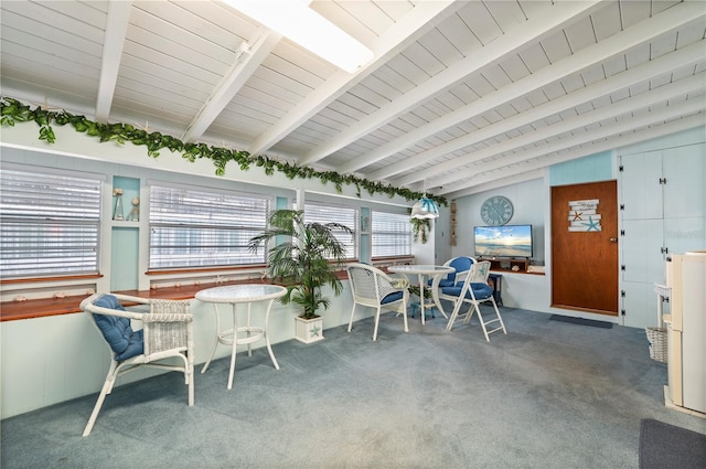 sunroom with vaulted ceiling with beams