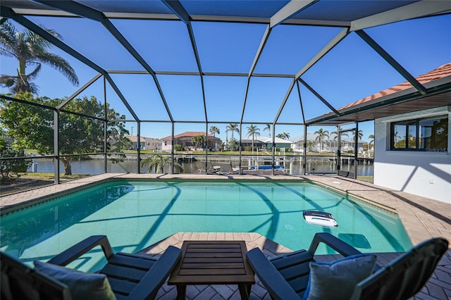 view of pool with a water view and glass enclosure