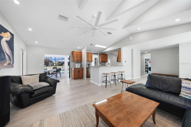 living room featuring light wood-type flooring, ceiling fan, and lofted ceiling