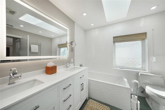 bathroom with a relaxing tiled tub, toilet, and vanity