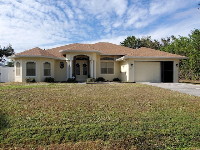 1057 Staley St, Port Charlotte, FL 33952 - view of front of house featuring stucco siding, french doors, driveway, a front yard, and a garage