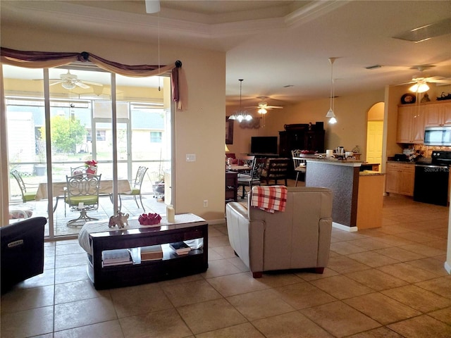 tiled living room with a tray ceiling