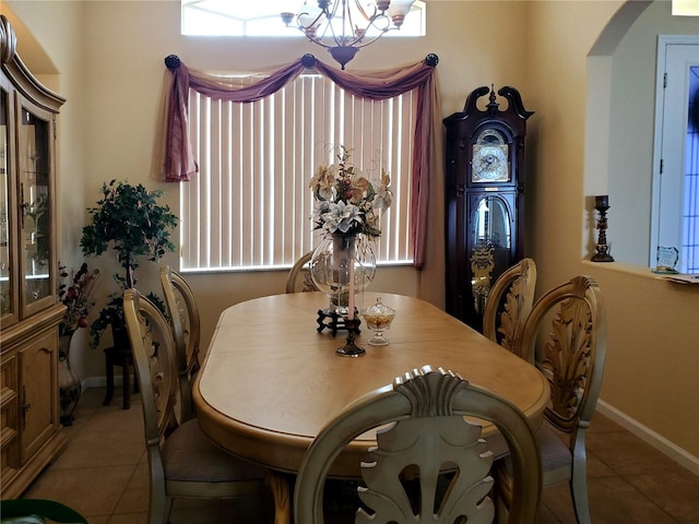 tiled dining space with a notable chandelier