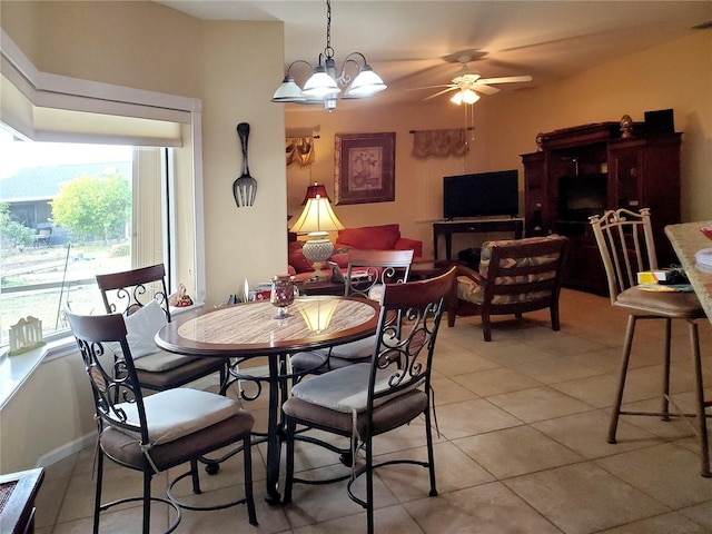 tiled dining room featuring ceiling fan with notable chandelier