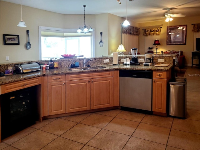 kitchen featuring dishwasher, pendant lighting, tile patterned flooring, ceiling fan with notable chandelier, and sink