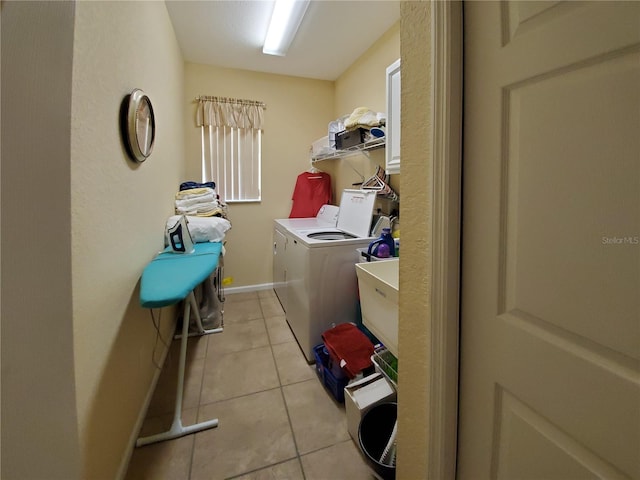 washroom featuring washer and dryer and light tile patterned floors