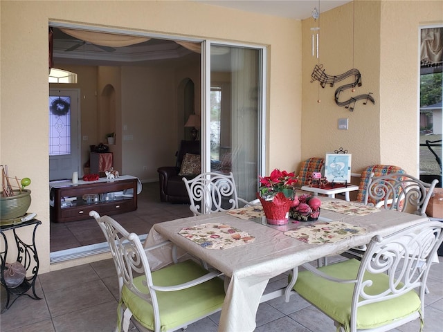 dining room with crown molding and tile patterned floors