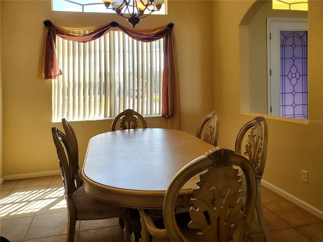1057 Staley St, Port Charlotte, FL 33952 - dining area featuring light tile patterned floors, arched walkways, baseboards, and a chandelier