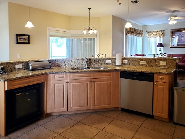 1057 Staley St, Port Charlotte, FL 33952 - kitchen with dishwasher, a sink, stone counters, decorative light fixtures, and ceiling fan with notable chandelier
