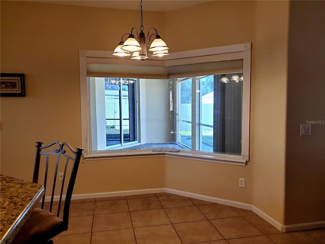 1057 Staley St, Port Charlotte, FL 33952 - unfurnished dining area with light tile patterned flooring, baseboards, and a notable chandelier