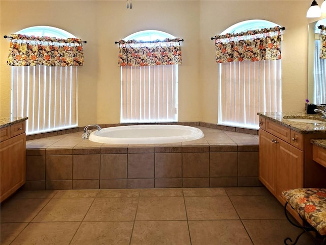 1057 Staley St, Port Charlotte, FL 33952 - bathroom featuring a garden tub, tile patterned flooring, and vanity