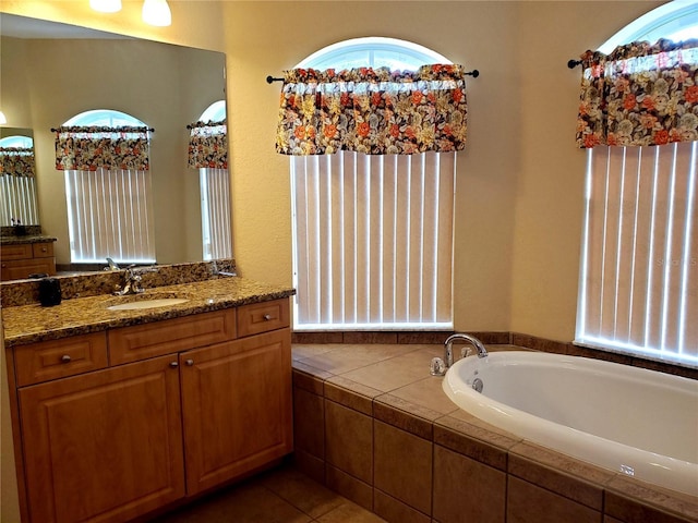 1057 Staley St, Port Charlotte, FL 33952 - bathroom featuring vanity, tile patterned flooring, and a bath