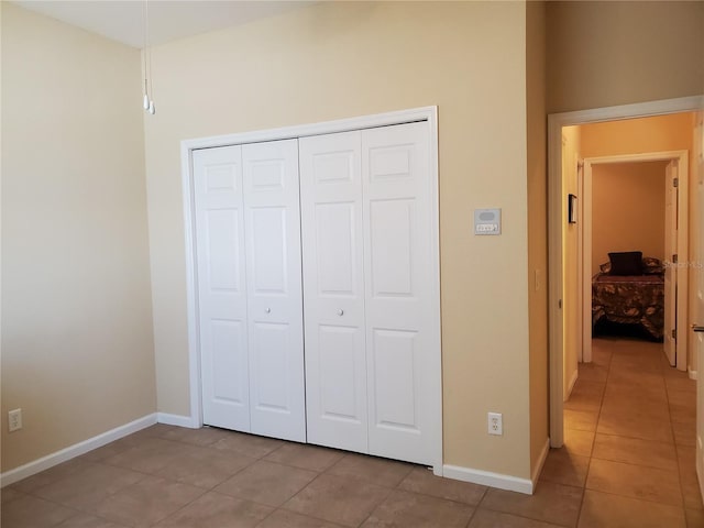 1057 Staley St, Port Charlotte, FL 33952 - unfurnished bedroom featuring light tile patterned floors, a closet, and baseboards