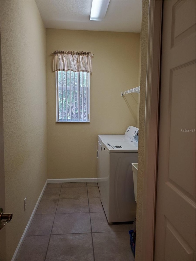 1057 Staley St, Port Charlotte, FL 33952 - laundry room with baseboards, washer and dryer, laundry area, and light tile patterned floors
