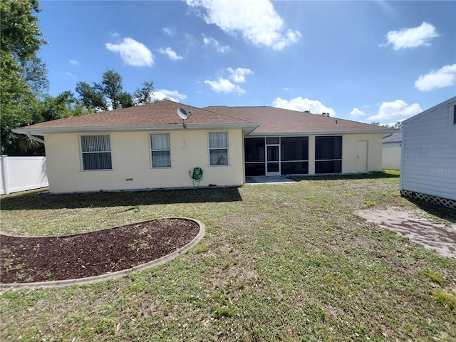1057 Staley St, Port Charlotte, FL 33952 - rear view of house with stucco siding, a sunroom, fence, and a yard