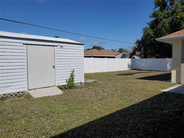1057 Staley St, Port Charlotte, FL 33952 - view of yard with an outbuilding, a storage unit, and a fenced backyard