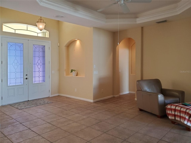 1057 Staley St, Port Charlotte, FL 33952 - entryway featuring crown molding, a raised ceiling, arched walkways, ceiling fan, and visible vents