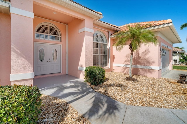 view of exterior entry featuring a garage