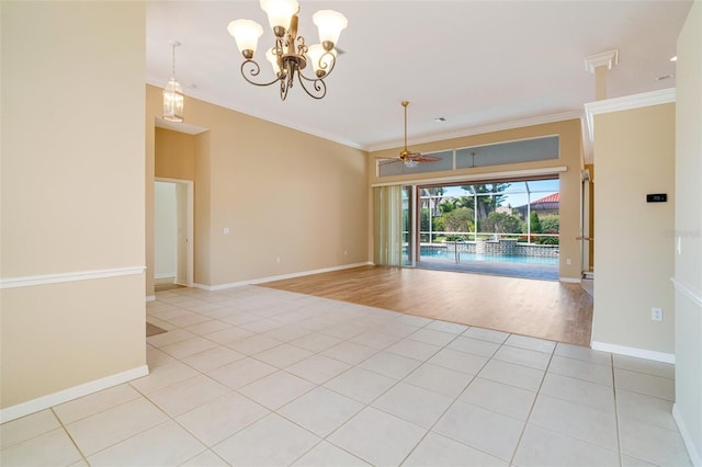 tiled empty room featuring ornamental molding and ceiling fan with notable chandelier