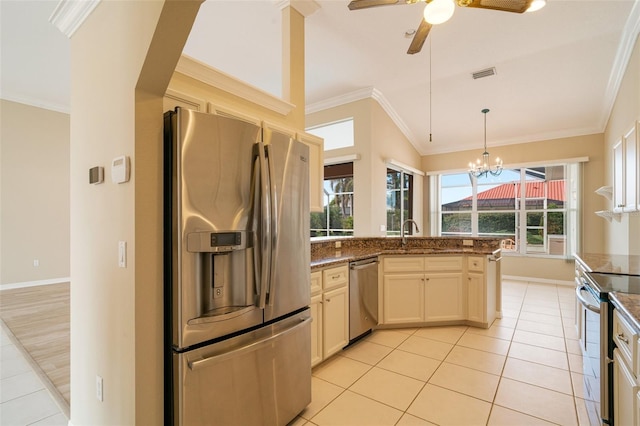 kitchen featuring sink, light tile patterned floors, crown molding, stainless steel appliances, and dark stone counters