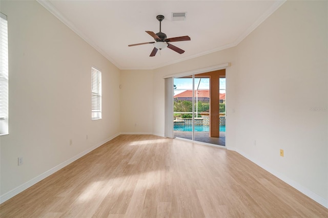 unfurnished room featuring light hardwood / wood-style flooring, plenty of natural light, and ornamental molding