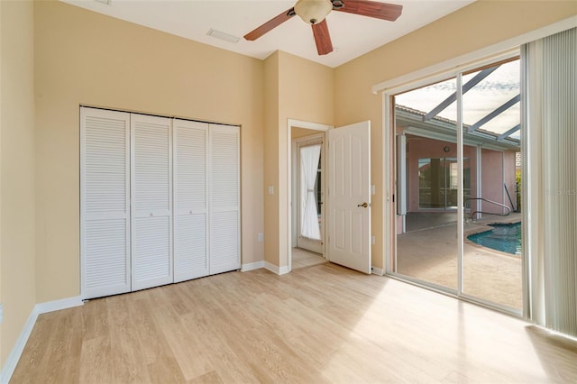 unfurnished bedroom with access to outside, light hardwood / wood-style floors, and ceiling fan