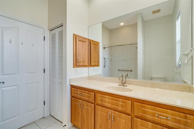 bathroom featuring vanity, toilet, and tile patterned flooring