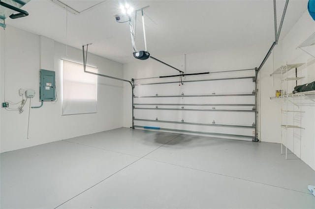 garage with a garage door opener and electric panel