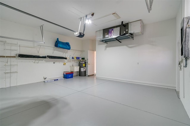 garage with sink, a garage door opener, and water heater