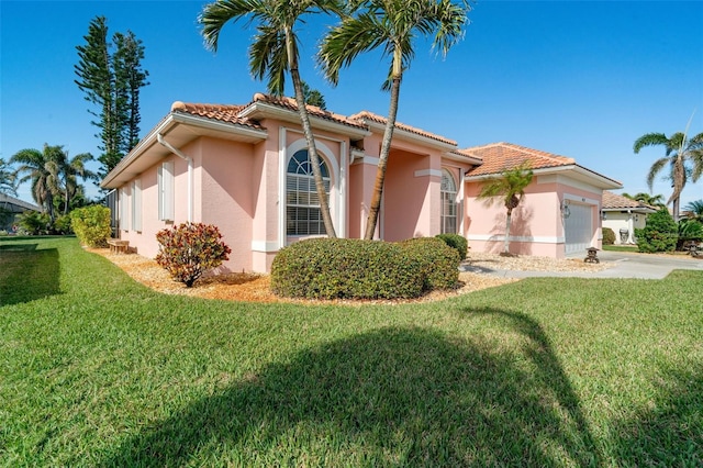 mediterranean / spanish-style home featuring a garage and a front lawn