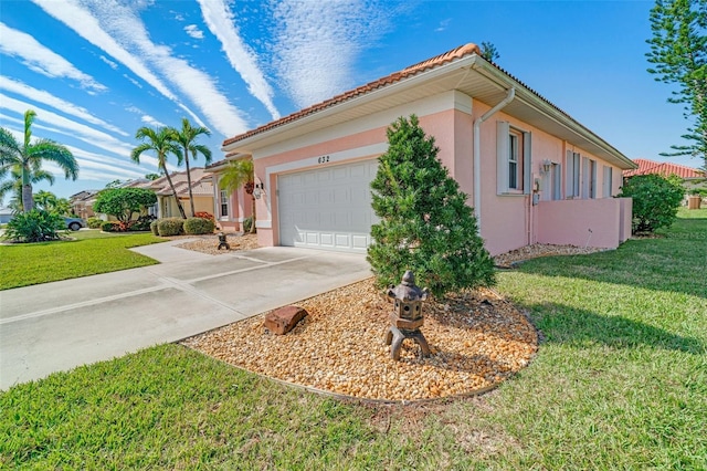 view of front of house featuring a garage and a front lawn