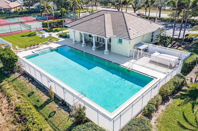 view of swimming pool featuring a patio area and a lawn