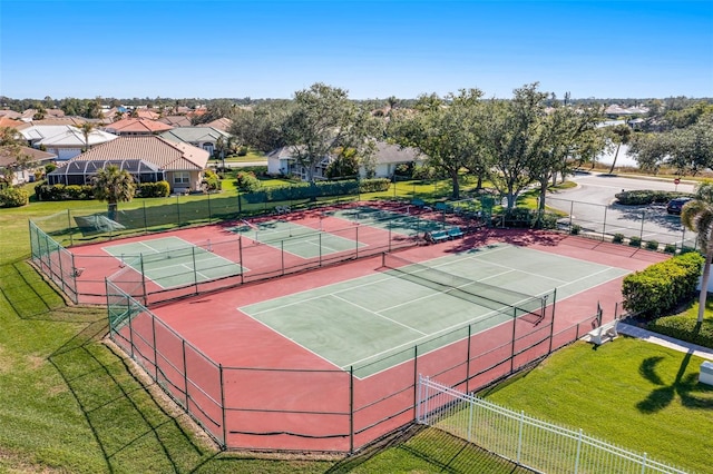 view of tennis court with a lawn