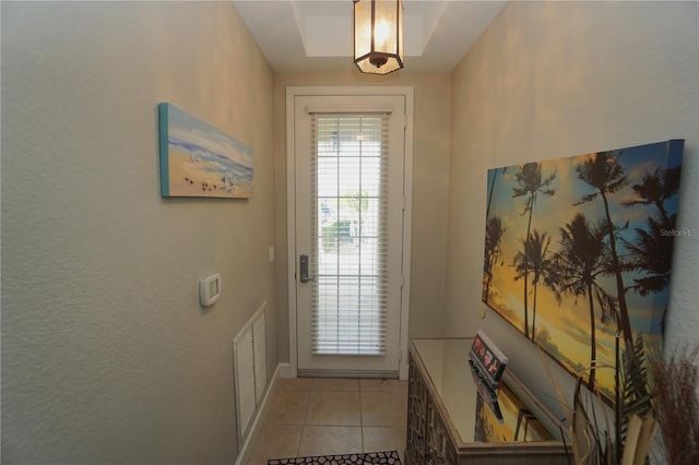 doorway featuring light tile patterned flooring