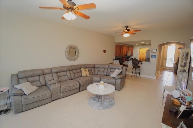 tiled living room with ceiling fan