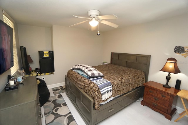 bedroom with ceiling fan and light colored carpet