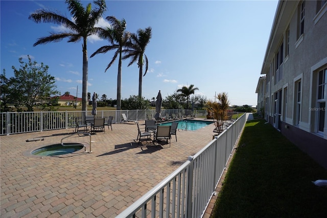 view of pool featuring a community hot tub and a patio area