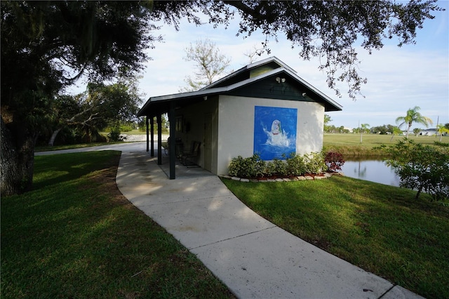 exterior space featuring a yard and a water view