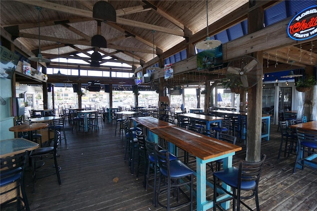 interior space with beam ceiling, high vaulted ceiling, and hardwood / wood-style floors