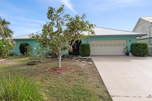 view of front of property featuring a garage and a front yard