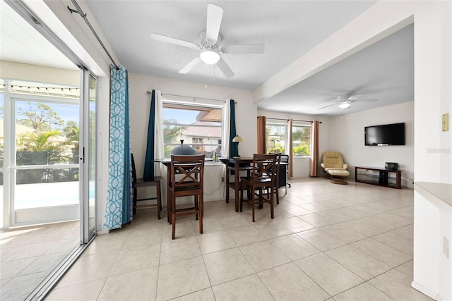 tiled dining space with ceiling fan